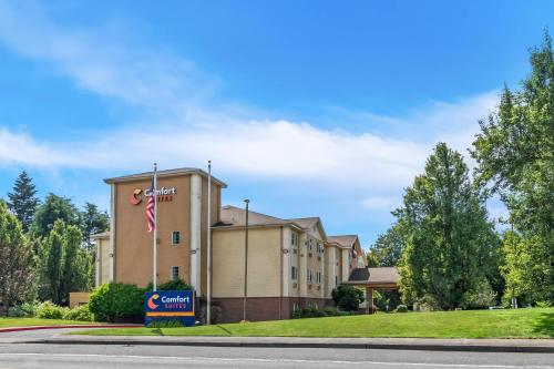 a building with a sign in front of it at Comfort Suites Clackamas in Clackamas