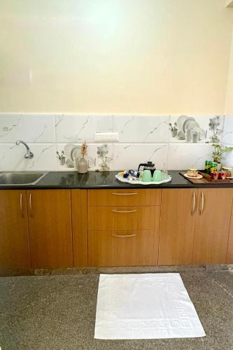 a kitchen with a sink and a counter top at Visaara Luxury Homes in Kammasandra