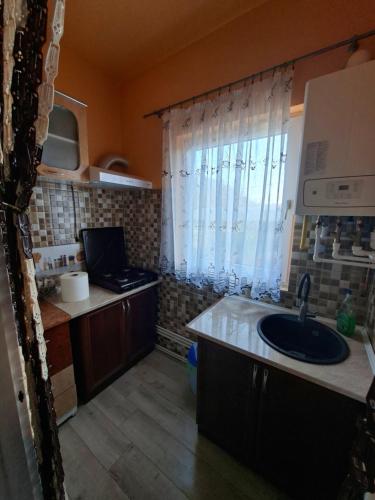 a small kitchen with a sink and a window at Altan's Gold in Hangul