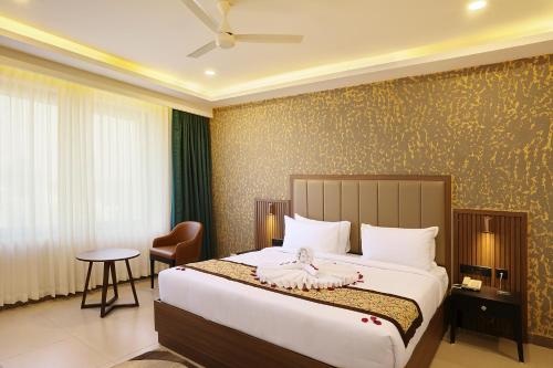 a bedroom with a bed with a doll on it at Parays Fernwoods in Mannārakkāt