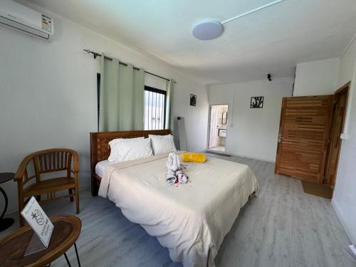 a bedroom with a bed with a stuffed animal on it at Authentica Private Villa by Oceanaxe Holidays in Calodyne