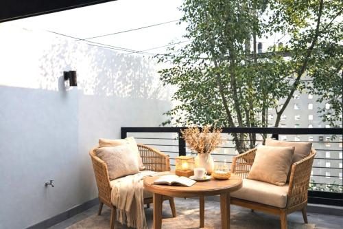 a patio with a table and chairs on a balcony at Vantara Private Villa Chiang Mai in Chiang Mai