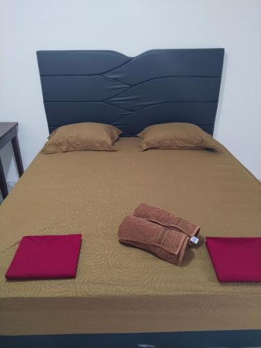 a bed with two towels and two pillows on it at EL Homestay Bunaken in Bunaken