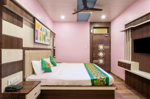 a bedroom with a bed and a tv in it at Treebo Saumendra Residency in Varanasi