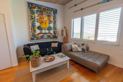 a living room with a couch and a table at Saltwater 5 - sleeps 8 - close to Main Beach in Point Lookout