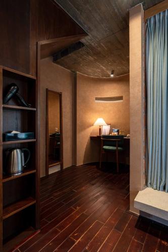 a living room with a table and a desk at The Memory Danang Boutique in Danang