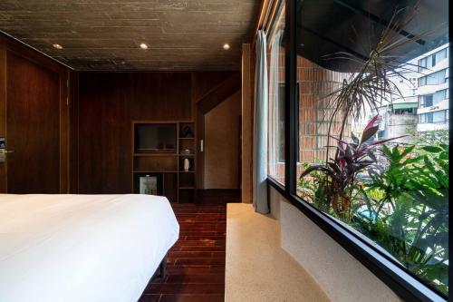a bedroom with a bed and a large window at The Memory Danang Boutique in Danang