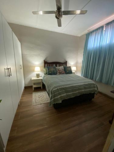 a bedroom with a bed and a ceiling fan at 22 Symmonds Studio in Melmoth