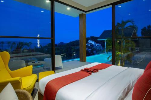 a bedroom with a bed and a large window at Luxury Sea View Jungle Beach Villa Walk to Beach in Ban Bang Po