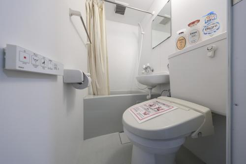 a small bathroom with a toilet and a sink at Tsurumai Nagoya Stay in Nagoya