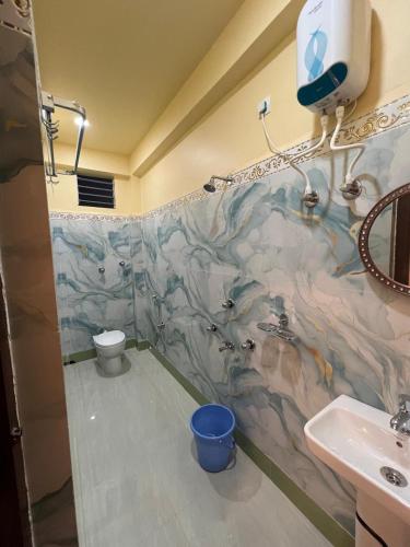a bathroom with a shower and a toilet and a sink at Hotel Raj in mayapur