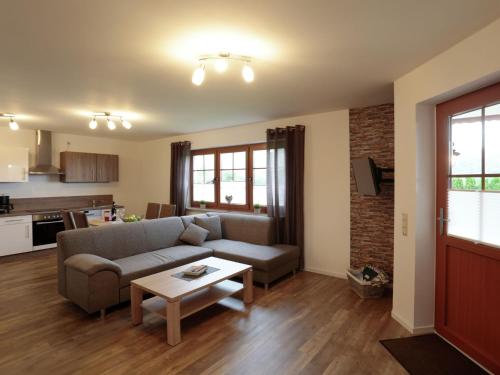 a living room with a couch and a table at Holiday flat in the Sauerland with terrace in Medebach