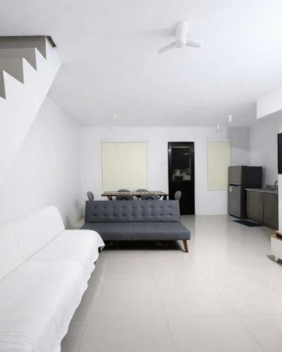 a living room with a couch and a table at Ben & Ben 2 in Cebu
