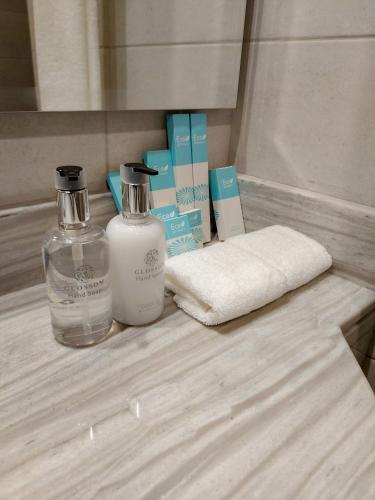 two bottles of soap and a towel on a counter at Grand Stay Holiday Homes Rental in Dubai