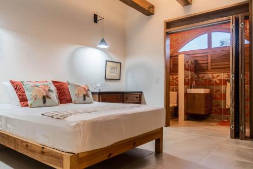 a bedroom with a bed and a glass door at Casa Rita! Relaxing two bedroom getaway! in Puerto Escondido