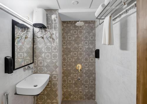 a bathroom with a toilet and a sink and a shower at Rooms To Go - Indian Guest only in Vadodara