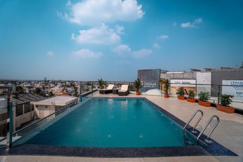 a swimming pool on the roof of a building at Aura Inn & Suites in Mysore