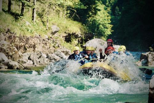 a group of people on a raft in a river at Rafting Camp Palfau in Palfau