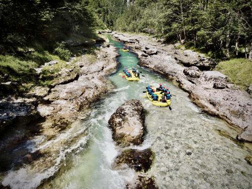a group of people are rafting down a river at Rafting Camp Palfau in Palfau