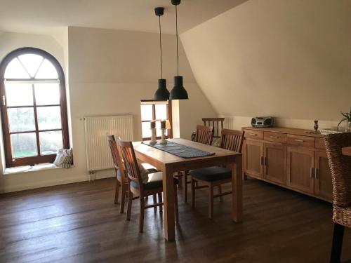 a kitchen with a dining room table and chairs at Ferienhof Martens in Sörup