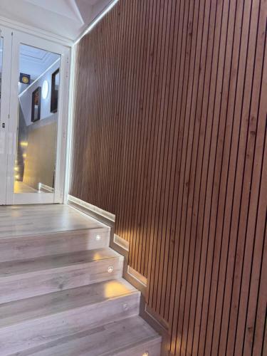 a wooden staircase in a building with a wooden wall at Pension Norte in Portugalete