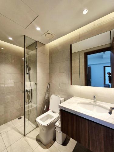 a bathroom with a toilet and a sink and a shower at Swanbay - Rice's House in Nhơn Trạch