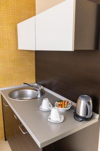a kitchen counter top with a sink and a sink at Garni Hotel Nevski in Belgrade