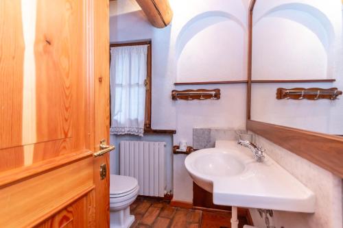 a bathroom with a sink and a toilet at Tabia Maredane in Falcade