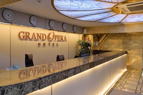 a lobby of a grand opera hotel with clocks on the wall at GRAND OPERA HOTEL in Almaty