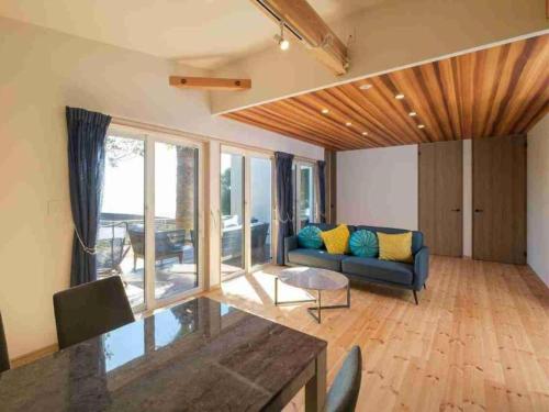 a living room with a couch and a table at VILLA YAHACHI GARDEN in Tahara
