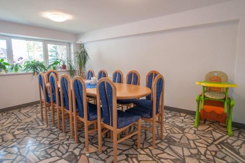 a dining room with a wooden table and chairs at Nasz Dom in Kościelisko