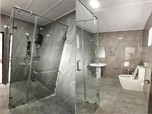 a bathroom with a shower and a toilet and a sink at Royal Star Guest House in Jaffna