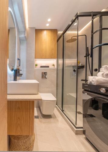 a bathroom with a sink and a shower at Aqua Lora in Nikiana