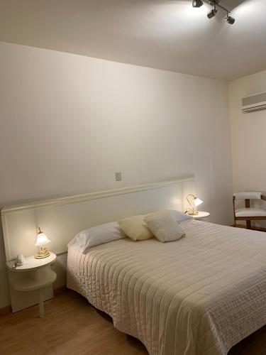 a bedroom with a bed with two tables and two lamps at G&D Winter Home in Milano Marittima