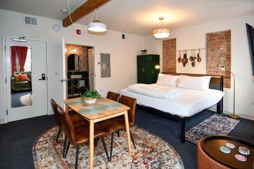 a bedroom with a bed and a table and chairs at HighRoad Washington DC in Washington, D.C.