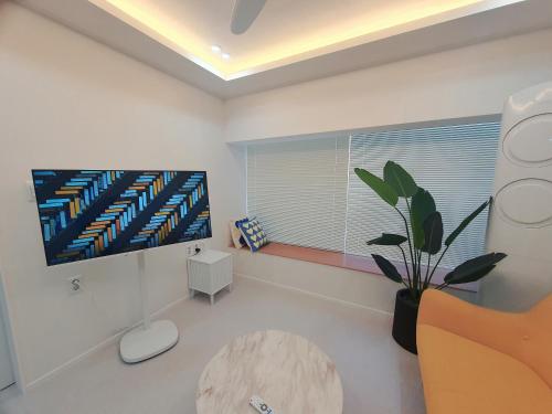 a living room with a tv and a table at Stay Ali in Gyeongju