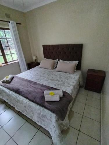 a bedroom with a large bed with two towels on it at Montreux in Richards Bay