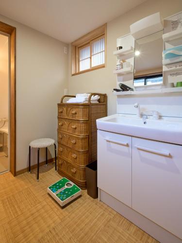 a bathroom with a sink and a counter with a scale at The Cross Inn Gujo in Gujo