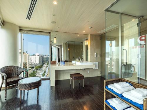 a bathroom with a sink and a mirror at KOKO HOTEL Premier Hakata in Fukuoka
