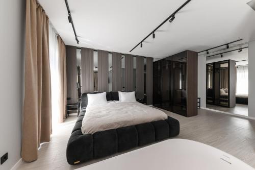 a bedroom with a large bed in a room at MM GROUP APARTMENT Dastor in Uzhhorod