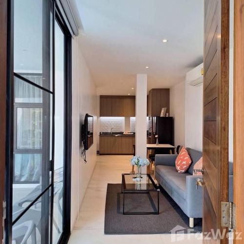 a living room with a couch and a table at White Cube House in Nathon Bay