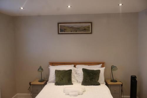 a bedroom with a bed with a stuffed animal on it at Airy 3 bedroom House in Norwood