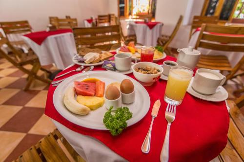 a table with a plate of food on a red table cloth at Hotel 3 Banderas in Cartagena de Indias