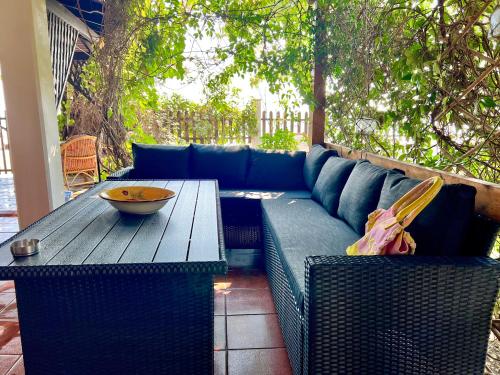 a blue couch and a wooden table on a patio at The SeaSide Villas in Nikiti