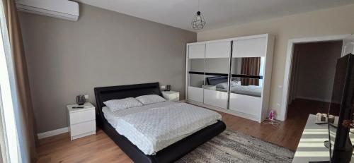 a bedroom with a bed and a large mirror at Anca House in Baia Mare