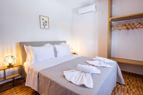 a bedroom with a large bed with towels on it at Enalia Suites in Amoopi