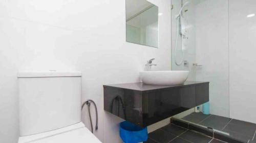 a bathroom with a sink and a mirror at Maritime Full Seaview Duplex Suites in George Town