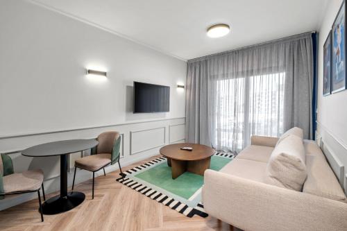 a living room with a couch and a table at Maestro St Lazar Apartments in Larnaca