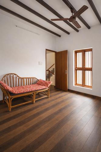 a room with a bench in the middle of a room at MAK Mansion in Kotikulam