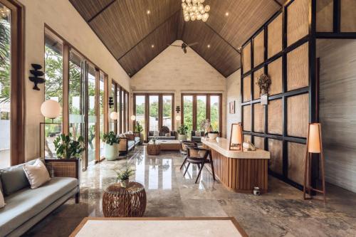 a living room with a couch and a table at Astera Villa Seminyak by Ini Vie Hospitality in Seminyak